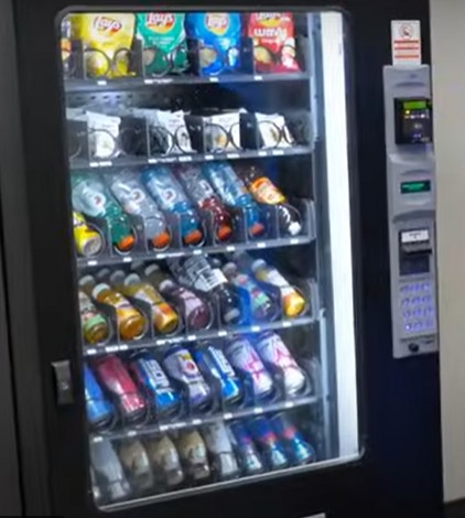 Happy snackers at a bright, modern machine